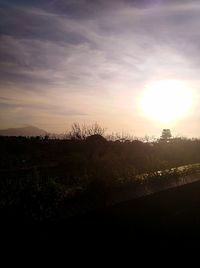 Scenic view of silhouette field against sky during sunset