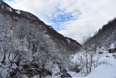 Scenic view of snow covered mountains against sky