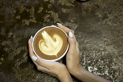 Woman holding coffee cup