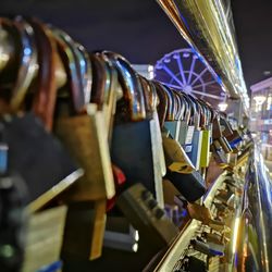 Close-up of padlocks hanging on railing