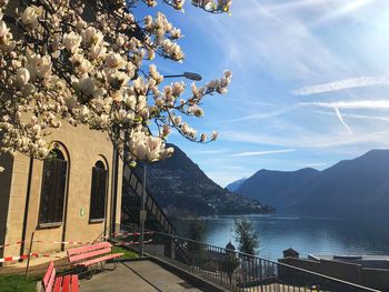 Scenic view of lake by mountains against sky