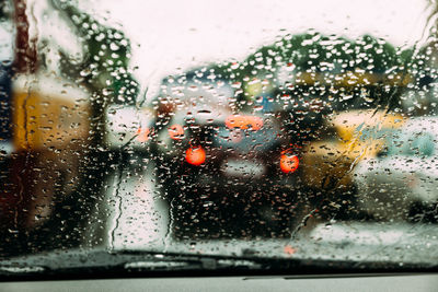 Wet car windshield in rainy season