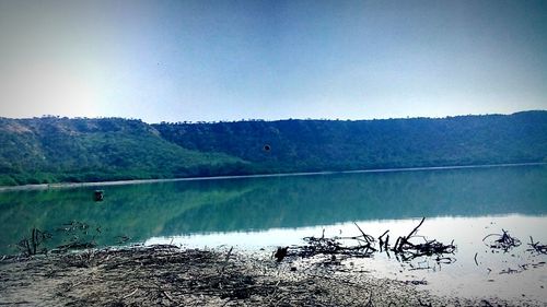 Scenic view of lake against clear blue sky