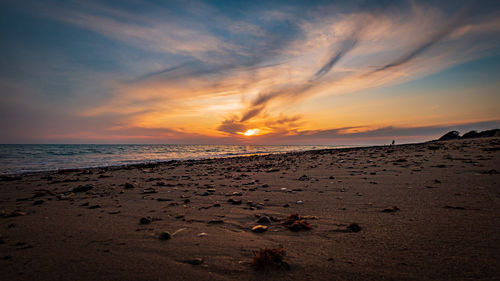 Scenic view of beach against sky during sunset