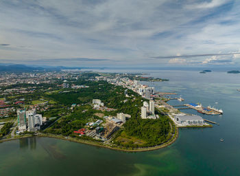 High angle view of city by sea against sky