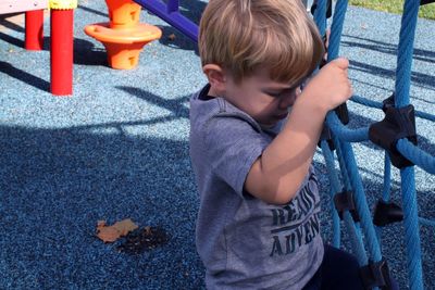 Boy playing with arms outstretched standing outdoors