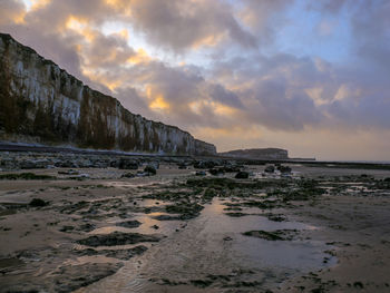 Scenic view of beach against sky during sunset