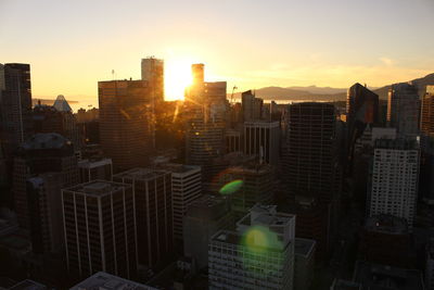 Buildings in city during sunset