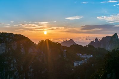 Scenic view of mountains against sky at sunset