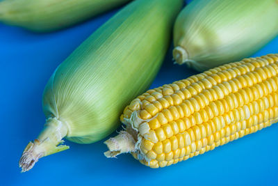 High angle view of green beans against blue background