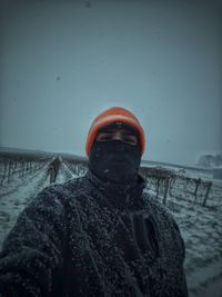 Close-up of man in snow against sea during winter