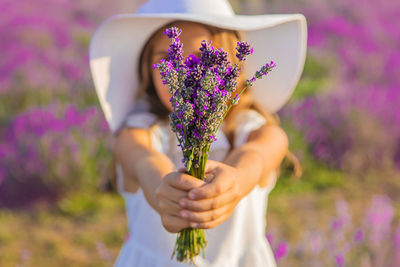 Cute girl holding flower in farm