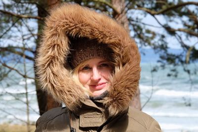 Portrait of smiling woman wearing fur hood