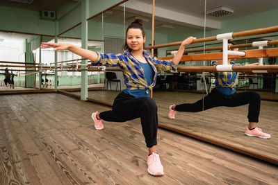 Pretty black woman is engaged in contemporary dance alone in the choreography hall. self-training.