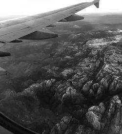Aerial view of airplane wing over landscape