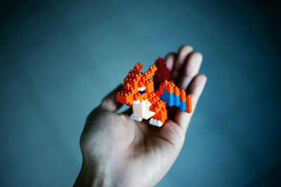 Woman's hand holding plastic bricks