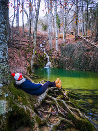 Full length of boy sitting on rock