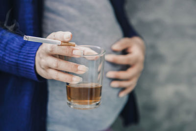 Close-up of hand holding drink