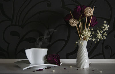 White roses in vase on table