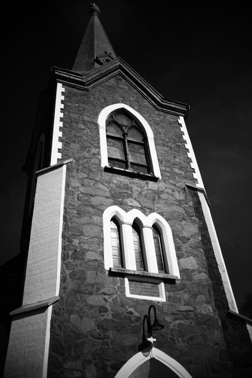 building exterior, architecture, low angle view, religion, built structure, church, place of worship, spirituality, cross, window, sky, no people, tower, outdoors, lighting equipment, day, cathedral, high section