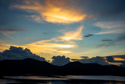 Scenic view of silhouette mountains against sky during sunset