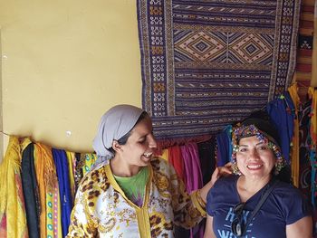 Portrait of happy woman standing by vendor at market