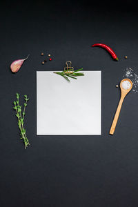 High angle view of chili pepper on table against black background