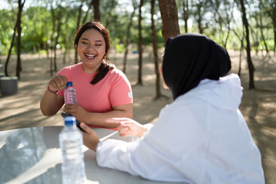 Portrait of young woman drinking water