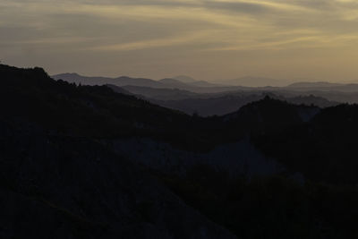 Scenic view of silhouette mountains against sky during sunset