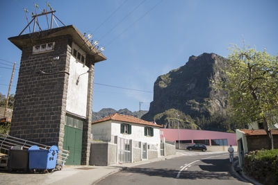 Road amidst buildings against sky