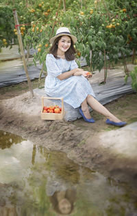 Portrait of a smiling young woman sitting outdoors