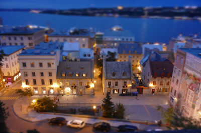 High angle view of illuminated street amidst buildings in city