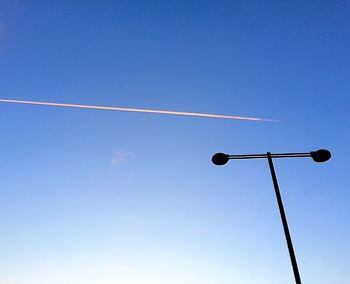 Low angle view of street light against clear blue sky