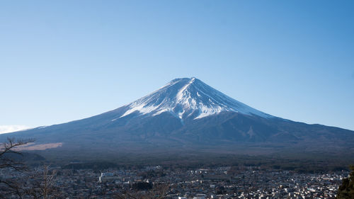 Scenic view of mountains against clear blue sky