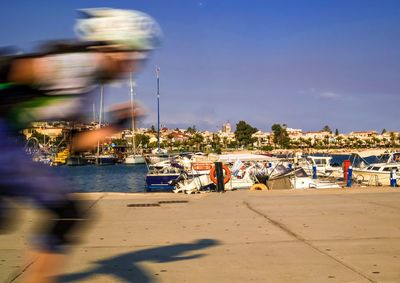 Blurred motion of man running outdoors against sky