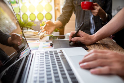 Midsection of people on table