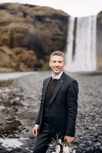 Portrait of young man standing outdoors