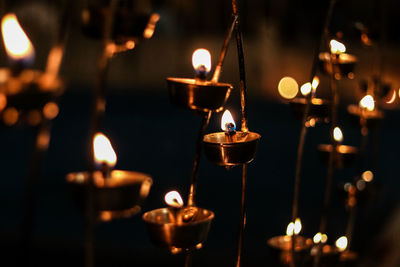 Close-up of lit tea light candles in temple