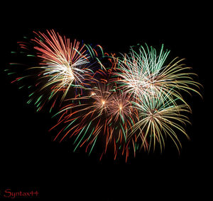 Low angle view of firework display at night