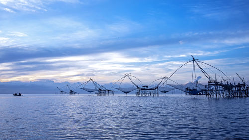Sailboats in sea against sky
