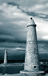 Lighthouse against cloudy sky