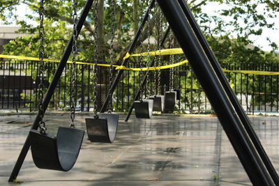 View of closed swing set in playground