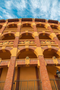 Low angle view of building against cloudy sky