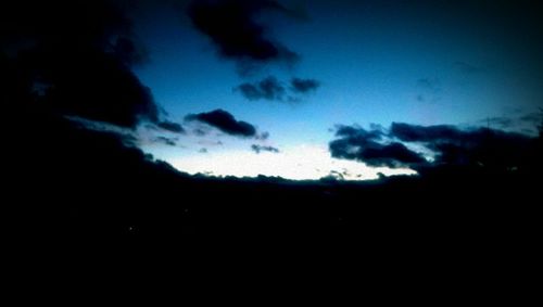 Low angle view of cloudy sky at night