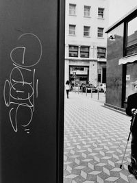 Man walking by building in city