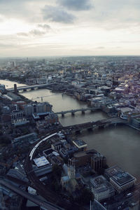 High angle view of bridges over river amidst city against sky