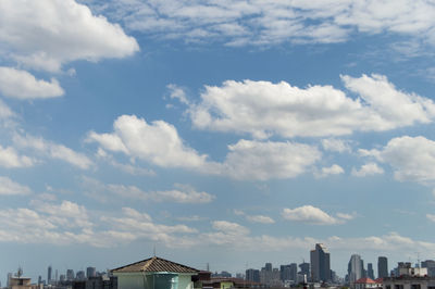 Buildings against cloudy sky