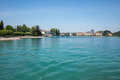 Scenic view of sea by buildings against sky