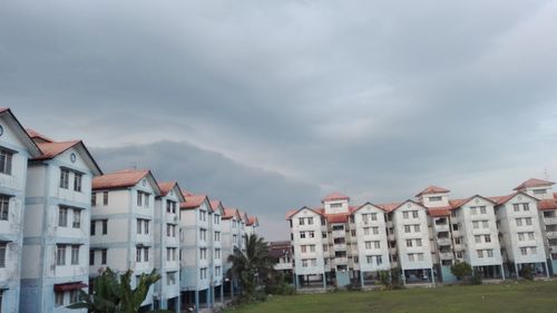 Houses in city against sky