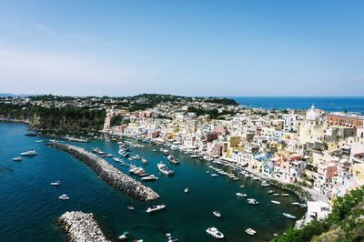 High angle view of townscape by sea against sky